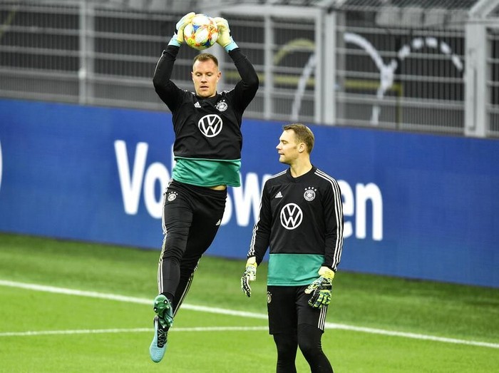 Germanys goalkeepers Marc-Andre ter Stegen, up, and Manuel Neuer, down, exercise during a training session of the national team on Tuesday, Oct. 8, 2019, prior a friendly soccer match between Germany and Argentina in Dortmund, Germany. (AP Photo/Martin Meissner)