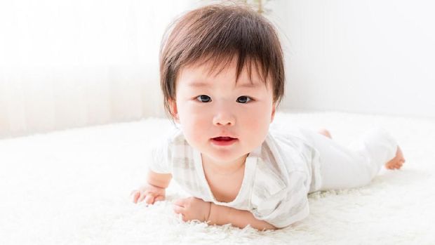 asian baby in living room