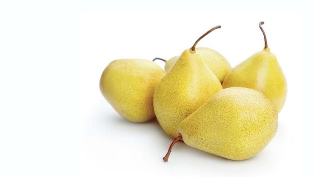 pile of ripe yellow pears isolated on white background