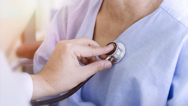 healthy concept; Doctor checking patient's heart with stethoscope at a hospital