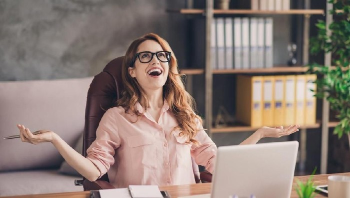 zodiak Close up photo beautiful she her business lady hand arm head raised up laugh laughter big salary income earnings genius startup notebook table sit office chair wearing specs formal-wear shirt.