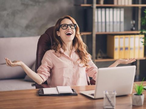 Close up photo beautiful she her business lady hand arm head raised up laugh laughter big salary income earnings genius startup notebook table sit office chair wearing specs formal-wear shirt.