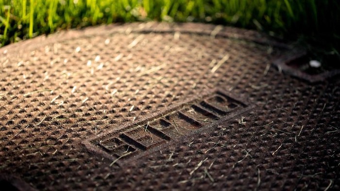 Septic Tank (Blake David Taylor/iStockphoto) Closed septic tank cover in a backyard