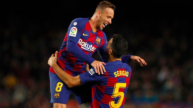 Barcelona's Arthur, left, celebrates with Barcelona's Sergio Busquets who scored his side's fourth goal during a Spanish La Liga soccer match between Barcelona and Celta at Camp Nou stadium in Barcelona, Saturday, Nov. 9, 2019. (AP Photo/Joan Monfort)