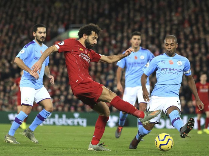 Liverpools Mohamed Salah, left, celebrates after scoring his sides second goal during the English Premier League soccer match between Liverpool and Manchester City at Anfield stadium in Liverpool, England, Sunday, Nov. 10, 2019. (AP Photo/Jon Super)