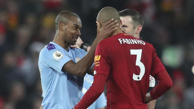 Manchester City's Fernandinho, left, apologies with Liverpool's Fabinho during the English Premier League soccer match between Liverpool and Manchester City at Anfield stadium in Liverpool, England, Sunday, Nov. 10, 2019. (AP Photo/Jon Super)