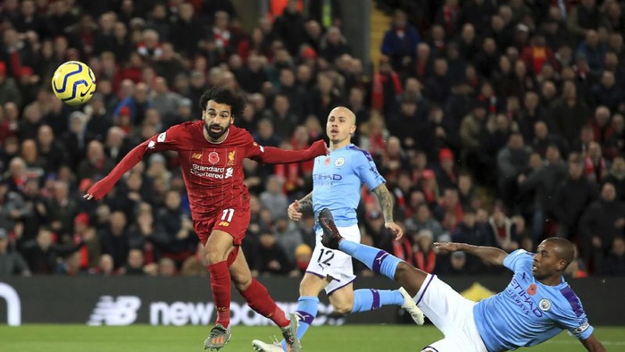 Liverpools Mohamed Salah, left, celebrates after scoring his sides second goal during the English Premier League soccer match between Liverpool and Manchester City at Anfield stadium in Liverpool, England, Sunday, Nov. 10, 2019. (AP Photo/Jon Super)
