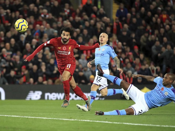 Liverpools Mohamed Salah, left, celebrates after scoring his sides second goal during the English Premier League soccer match between Liverpool and Manchester City at Anfield stadium in Liverpool, England, Sunday, Nov. 10, 2019. (AP Photo/Jon Super)