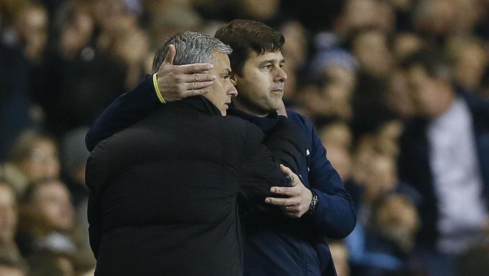 FILE - In this Thursday, Jan. 1, 2015 file photo Tottenham manager Mauricio Pochettino, right, embraces Chelsea manager Jose Mourinho at the end of the English Premier League soccer match between Tottenham Hotspur and Chelsea at White Hart Lane Stadium in London. Jose Mourinho sealed a return to coaching after almost a year out when he was hired as Tottenham manager on Wednesday Nov. 20, 2019 a day after the Premier League club fired Mauricio Pochettino. (AP Photo/Kirsty Wigglesworth, File)