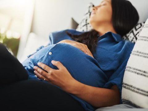 Shot of a pregnant woman sleeping on a bed at home