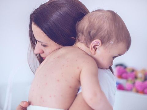 Mother nursing sick child At Home