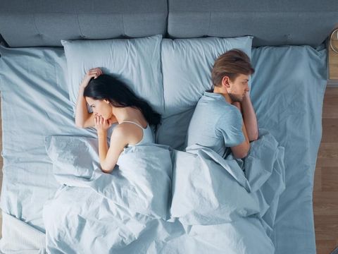 Quarrelling Young Couple in the Bed, Young People Lying Turned Away From Each other and Lay on Their Sides Holding Grudges and Being Offended