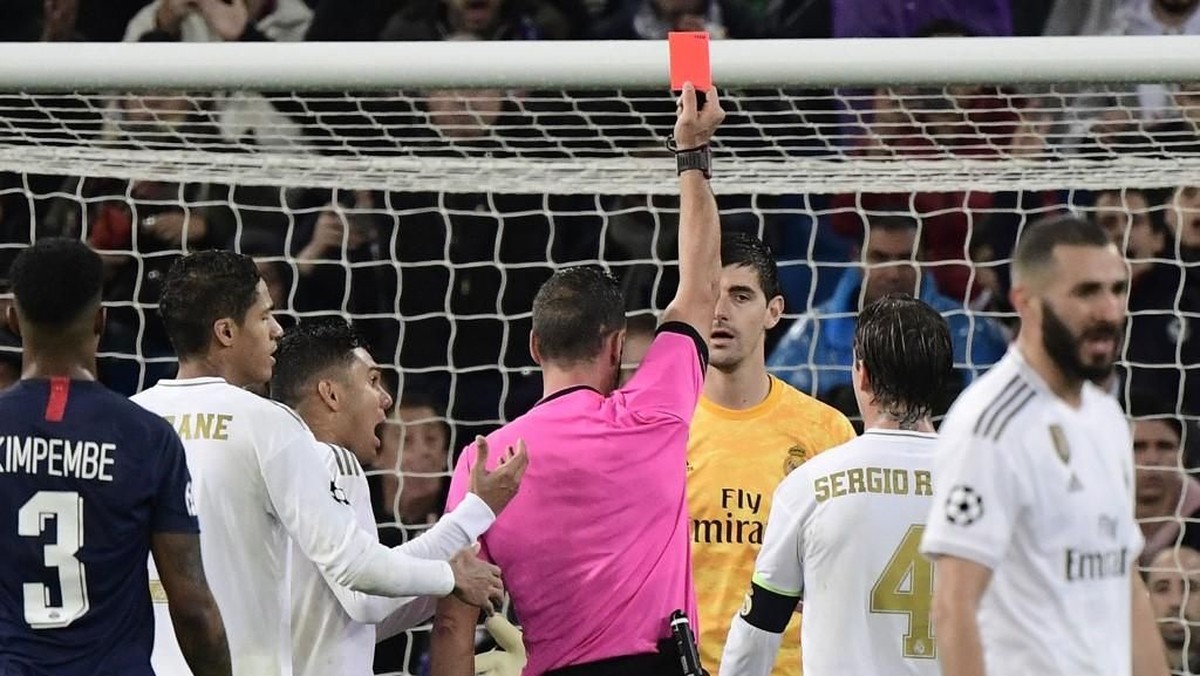 Wasit membatalkan kartu merah untuk Thibaut Courtois dalam laga Real Madrid vs PSG setelah mengecek VAR (Foto: JAVIER SORIANO / AFP)