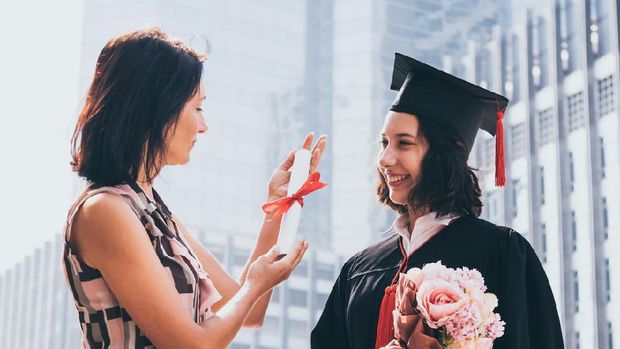 Beautiful woman congratulates for her daughter on graduation day, Successful concept