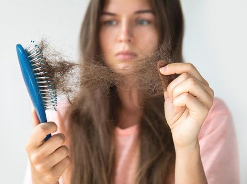 Young woman is very upset because of hair loss