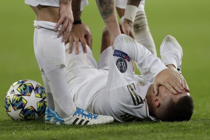 Real Madrids Eden Hazard reacts injured at the ground during a Champions League soccer match Group A between Real Madrid and Paris Saint Germain at the Santiago Bernabeu stadium in Madrid, Spain, Tuesday, Nov. 26, 2019. (AP Photo/Bernat Armangue)