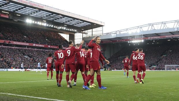 Liverpool's Virgil van Dijk centre right celebrates after scoring his second goal during the English Premier League soccer match between Liverpool and Brighton at Anfield Stadium, Liverpool, England, Saturday, Nov. 30, 2019. (AP Photo/Jon Super)