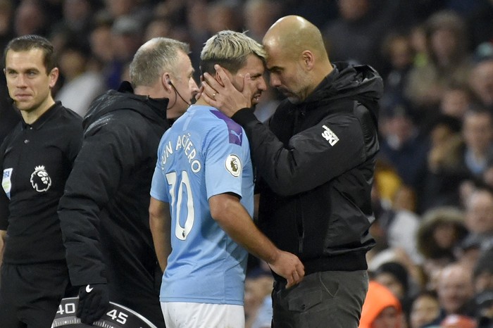 Manchester Citys head coach Pep Guardiola, right, talks with Sergio Aguero as he is substituted after getting injured during the English Premier League soccer match between Manchester City and Chelsea at Etihad stadium in Manchester, England, Saturday, Nov. 23, 2019. (AP Photo/Rui Vieira)
