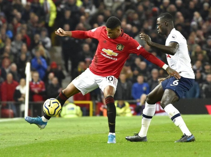 Manchester Uniteds Marcus Rashford, left, and Tottenhams Davinson Sanchez challenge for the ball during the English Premier League soccer match between Manchester United and Tottenham Hotspur at Old Trafford in Manchester, England, Wednesday, Dec. 4, 2019. (AP Photo/Rui Vieira)