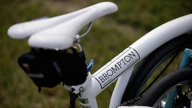 CHICHESTER, ENGLAND - JULY 28:  A bike wears the name Brompton at the Brompton World Championship folding bike race, which is part of the Orbital cycling festival at Goodwood Motor Circuit on July 28, 2013 in Chichester, England. The race starts with a Le-Mans style sprint to the rider's bike, which is then assembled and followed by a 15.2km ride. A strict dress code of jacket and tie applies, with an award going to the most stylishly dressed.  (Photo by Matthew Lloyd/Getty Images)