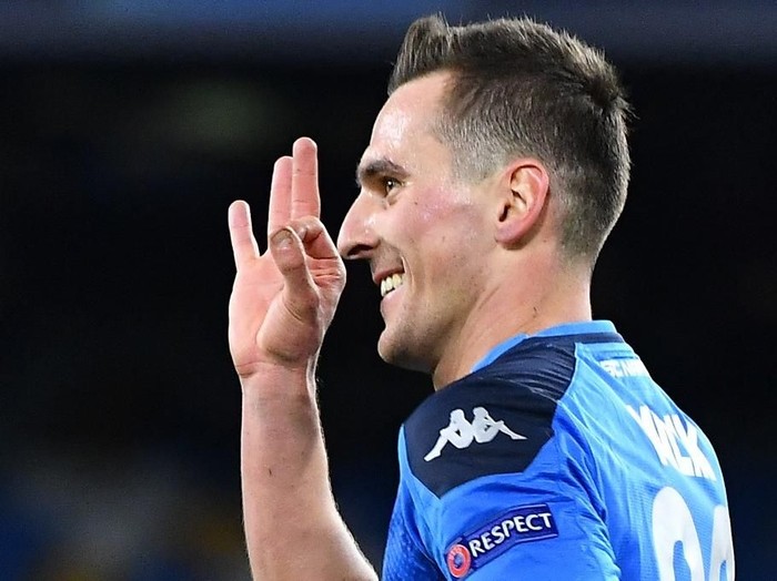 Napoli's Polish forward Arkadiusz Milik celebrates after scoring his third goal during the UEFA Champions League Group E football match Napoli vs Genk on December 10, 2019 at the San Paolo stadium in Naples. (Photo by Tiziana FABI / AFP)