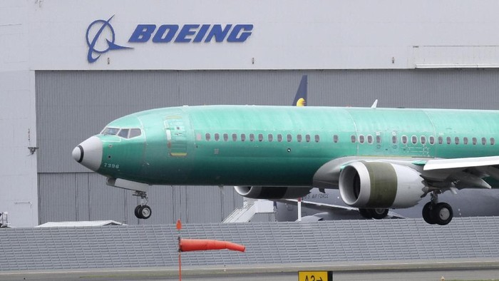 FILE - In this April 10, 2019, file photo a Boeing 737 MAX 8 airplane being built for India-based Jet Airways lands following a test flight at Boeing Field in Seattle. Boeing is reassuring airline industry leaders about the safety of the grounded 737 Max as it continues working to get the plane back in service. The aircraft maker invited about 30 union officials, safety experts and others to the Seattle area for two days of meetings with Boeing executives and factory tours. (AP Photo/Ted S. Warren, File)
