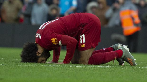 Liverpool's Mohamed Salah celebrates after scoring his sides second goal during the English Premier League soccer match between Liverpool and Watford at Anfield stadium in Liverpool, England, Saturday, Dec. 14, 2019. (AP Photo/Rui Vieira)