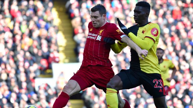 Watford's Ismaila Sarr, right, challenges Liverpool's James Milner during the English Premier League soccer match between Liverpool and Watford at Anfield stadium in Liverpool, England, Saturday, Dec. 14, 2019. (AP Photo/Rui Vieira)