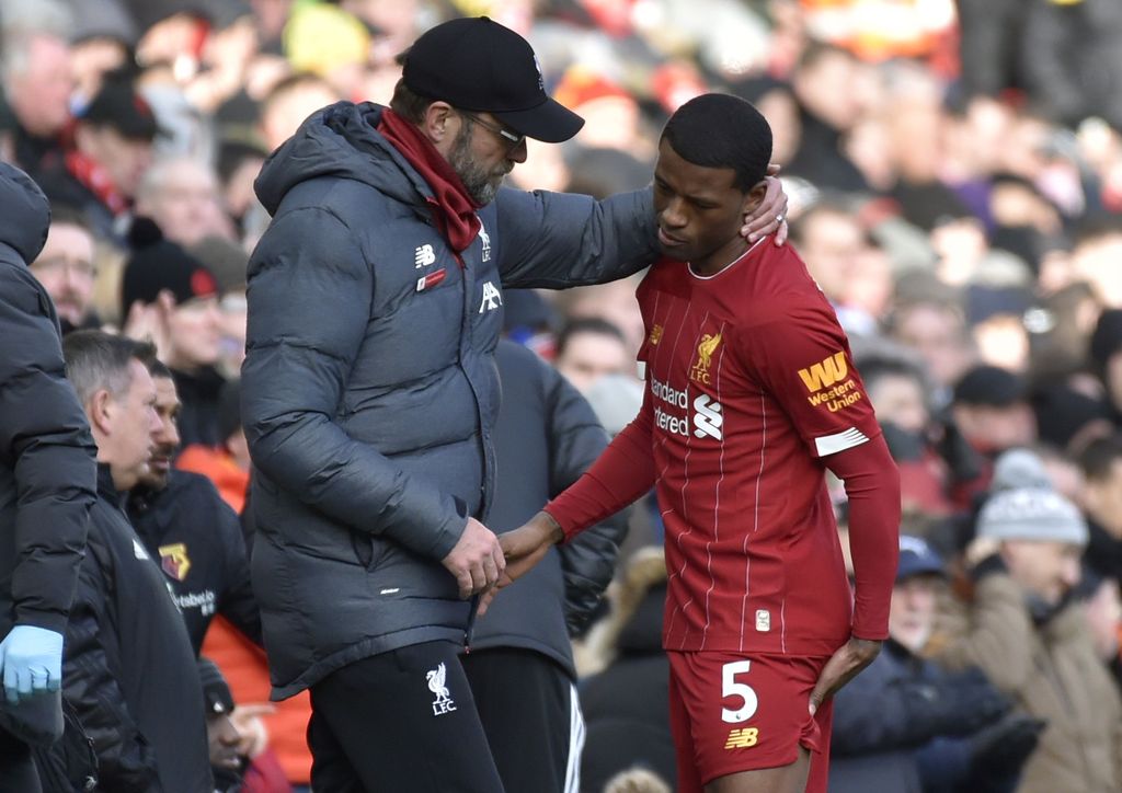 Liverpool's manager Jurgen Klopp, left, talks to Liverpool's Georginio Wijnaldum after he suffered an injury during the English Premier League soccer match between Liverpool and Watford at Anfield stadium in Liverpool, England, Saturday, Dec. 14, 2019. (AP Photo/Rui Vieira)