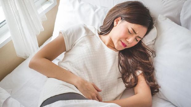 Asian woman stomachache, feel pain for period conceptAsian woman stomachache, feel pain for period concept