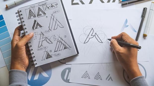 Graphic designer development process drawing sketch design creative Ideas draft Logo product trademark label brand artwork. Graphic designer studio Concept.