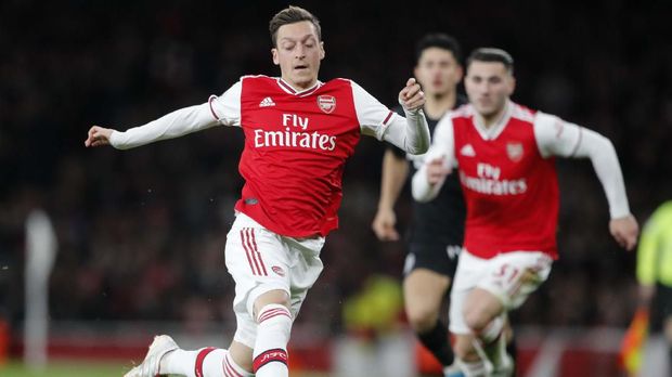 Arsenal's Mesut Ozil controls the ball during the English Premier League soccer match between Arsenal and Brighton, at the Emirates Stadium in London, Thursday, Dec. 5, 2019. (AP Photo/Frank Augstein)