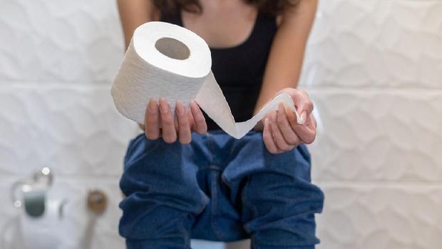 Woman sitting in the toilet