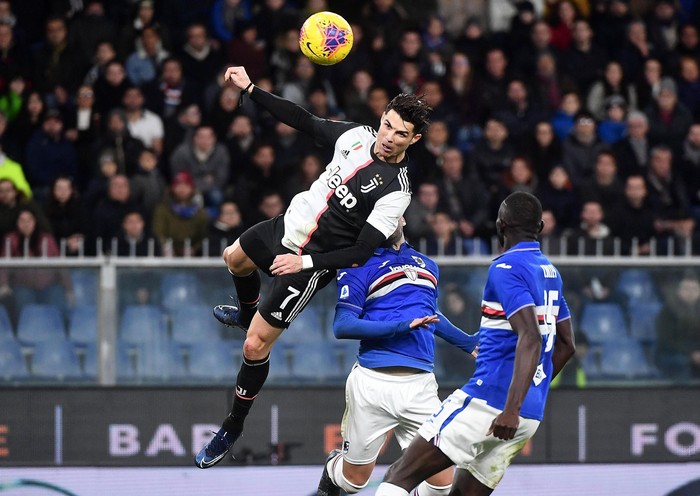 Juventus Cristiano Ronaldo, top, scores his sides second goal during a Serie A soccer match between Sampdoria and Juventus, at Luigi Ferraris stadium in Genoa, Italy, Wednesday, Dec. 18, 2019. (Luca Zennaro/ANSA via AP)