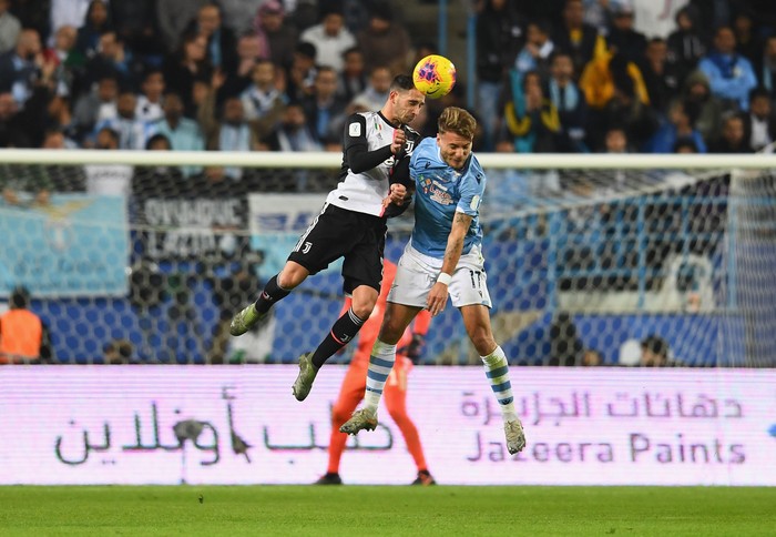 RIYADH, SAUDI ARABIA - DECEMBER 22: Ciro Immobile of SS Lazio competes for the ball against Mattia De Sciglio of Juventus during the Italian Supercup match between Juventus and SS Lazio  at King Saud University Stadium on December 22, 2019 in Riyadh, Saudi Arabia.  (Photo by Claudio Villa/Getty Images for Lega Serie A)