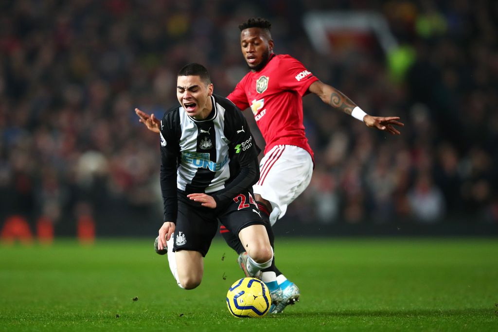 MANCHESTER, ENGLAND - DECEMBER 26: Fred of Manchester United tackles Miguel Almiron of Newcastle United during the Premier League match between Manchester United and Newcastle United at Old Trafford on December 26, 2019 in Manchester, United Kingdom. (Photo by Clive Brunskill/Getty Images)