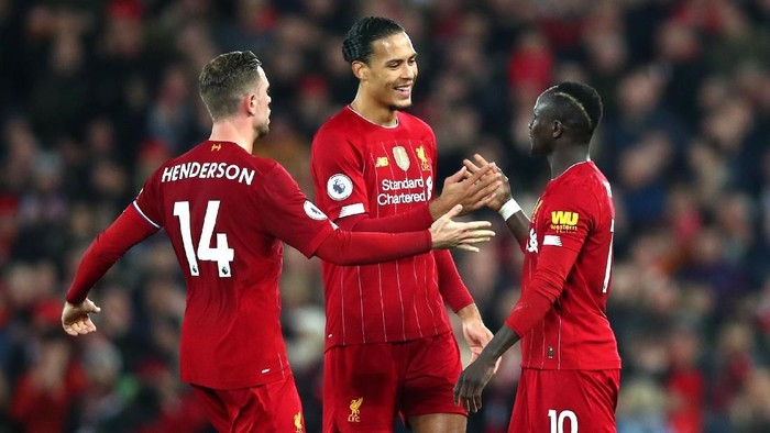 LIVERPOOL, ENGLAND - DECEMBER 29: Sadio Mane of Liverpool celebrates with Virgil van Dijk of Liverpool and Jordan Henderson of Liverpool after scoring his sides first goal during the Premier League match between Liverpool FC and Wolverhampton Wanderers at Anfield on December 29, 2019 in Liverpool, United Kingdom. (Photo by Clive Brunskill/Getty Images)