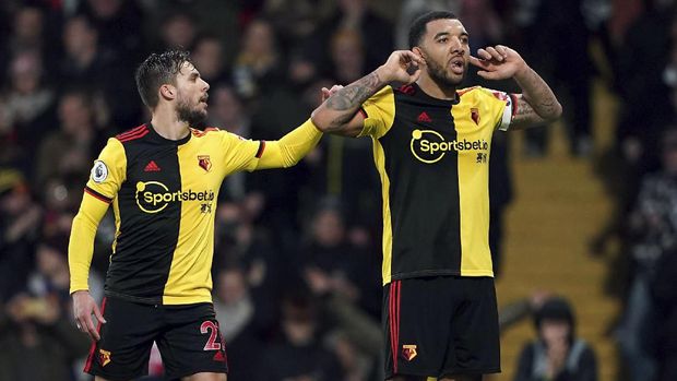 Watford's Troy Deeney, right, celebrates with Kiko Femenia after scoring against Aston Villa during the English Premier League soccer match at Vicarage Road, Watford, England, Saturday Dec. 28, 2019. (Tess Derry/PA via AP)
