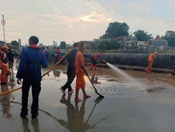 Banjir Surut, Damkar Jaktim Mulai Bersihkan Jalan Jatinegara Barat dari Lumpur