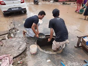 Bersihkan Lumpur Banjir, Warga Pondok Gede Permai Pakai Air Gorong-gorong