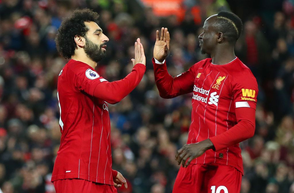 LIVERPOOL, ENGLAND - JANUARY 02: Mohamed Salah of Liverpool celebrates with Sadio Mane after scoring his team's first goal during the Premier League match between Liverpool FC and Sheffield United at Anfield on January 02, 2020 in Liverpool, United Kingdom. (Photo by Clive Brunskill/Getty Images)