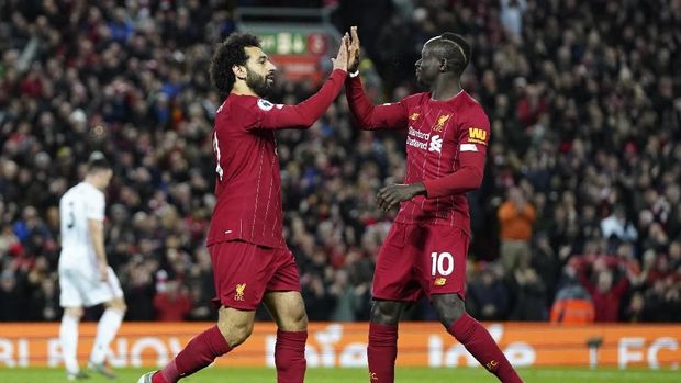 Liverpool's Mohamed Salah, front left, celebrates with Liverpool's Sadio Mane after scoring his side's opening goal during the English Premier League soccer match between Liverpool and Sheffield United at Anfield Stadium, Liverpool, England, Thursday, Jan. 2, 2020. (AP Photo/Jon Super)