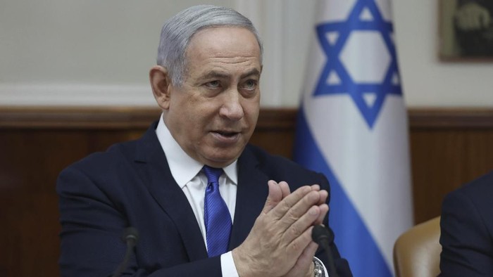 Benjamin Netanyahu File - In this Sunday, Dec. 29, 2019 file photo, Israeli Prime Minister Benjamin Netanyahu attends the weekly cabinet meeting at his office in Jerusalem. Netanyahu said Monday that he would seek immunity from corruption charges, likely delaying any trial until after March elections, when he hopes to have a majority coalition that will shield him from prosecution. (Abir Sultan /Pool photo via AP, File)