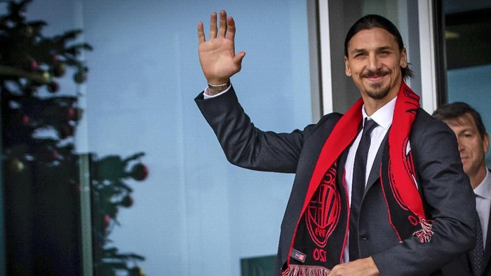 Zlatan Ibrahimovic wears an AC Milan scarf as he waves to his fans outside the AC Milan team headquarters, in Milan, Italy, Friday, Jan. 3, 2020.  The 38-year-old striker has been presented by AC Milan after signing a deal until the end of the season with an option to extend for another year. (Spada/LaPresse via AP)