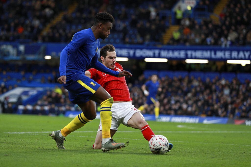 Nottingham Forest's Yuri Ribeiro tries to tackle Chelsea's Callum Hudson-Odoi, left, during an English FA Cup third round soccer match between Chelsea and Nottingham Forest at Stamford Bridge in London, Sunday, Jan. 5, 2020. (AP Photo/Ian Walton)