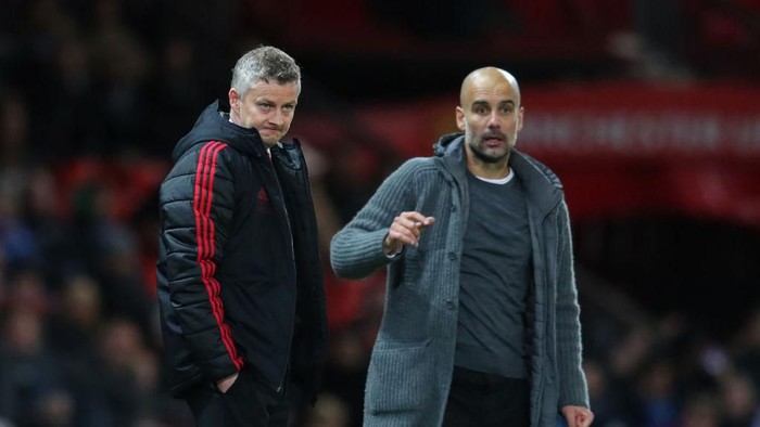 MANCHESTER, ENGLAND - APRIL 24: Ole Gunnar Solskjaer manager of Manchester United and Pep Guardiola the head coach / manager of Manchester City  during the Premier League match between Manchester United and Manchester City at Old Trafford on April 24, 2019 in Manchester, United Kingdom. (Photo by Catherine Ivill/Getty Images)