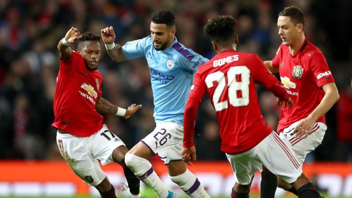 MANCHESTER, ENGLAND - JANUARY 07: Riyad Mahrez of Manchester City is challenged by Fred, Nemanja Matic and Angel Gomes of Manchester United during the Carabao Cup Semi Final match between Manchester United and Manchester City at Old Trafford on January 07, 2020 in Manchester, England. (Photo by Michael Steele/Getty Images)