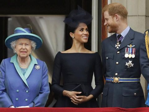 FILE - In this Tuesday, July 10, 2018 file photo Britain's Queen Elizabeth II, and Meghan the Duchess of Sussex and Prince Harry watch a flypast of Royal Air Force aircraft pass over Buckingham Palace in London. In a stunning declaration, Britain's Prince Harry and his wife, Meghan, said they are planning 