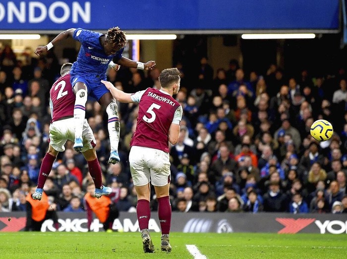 Chelseas Tammy Abraham, top, scores his sides second goal of the game, during the English Premier League soccer match between Chelsea and Burnley at Stamford Bridge, in London, Saturday, Jan. 11, 2020. (Victoria Jones/PA via AP)