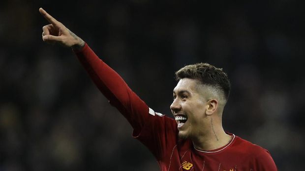 Liverpool's Roberto Firmino celebrates at the end of the English Premier League soccer match between Tottenham Hotspur and Liverpool at the Tottenham Hotspur Stadium in London, England, Saturday, Jan. 11, 2020. Firmino scored the goal in Liverpool's 1-0 win. (AP Photo/Matt Dunham)